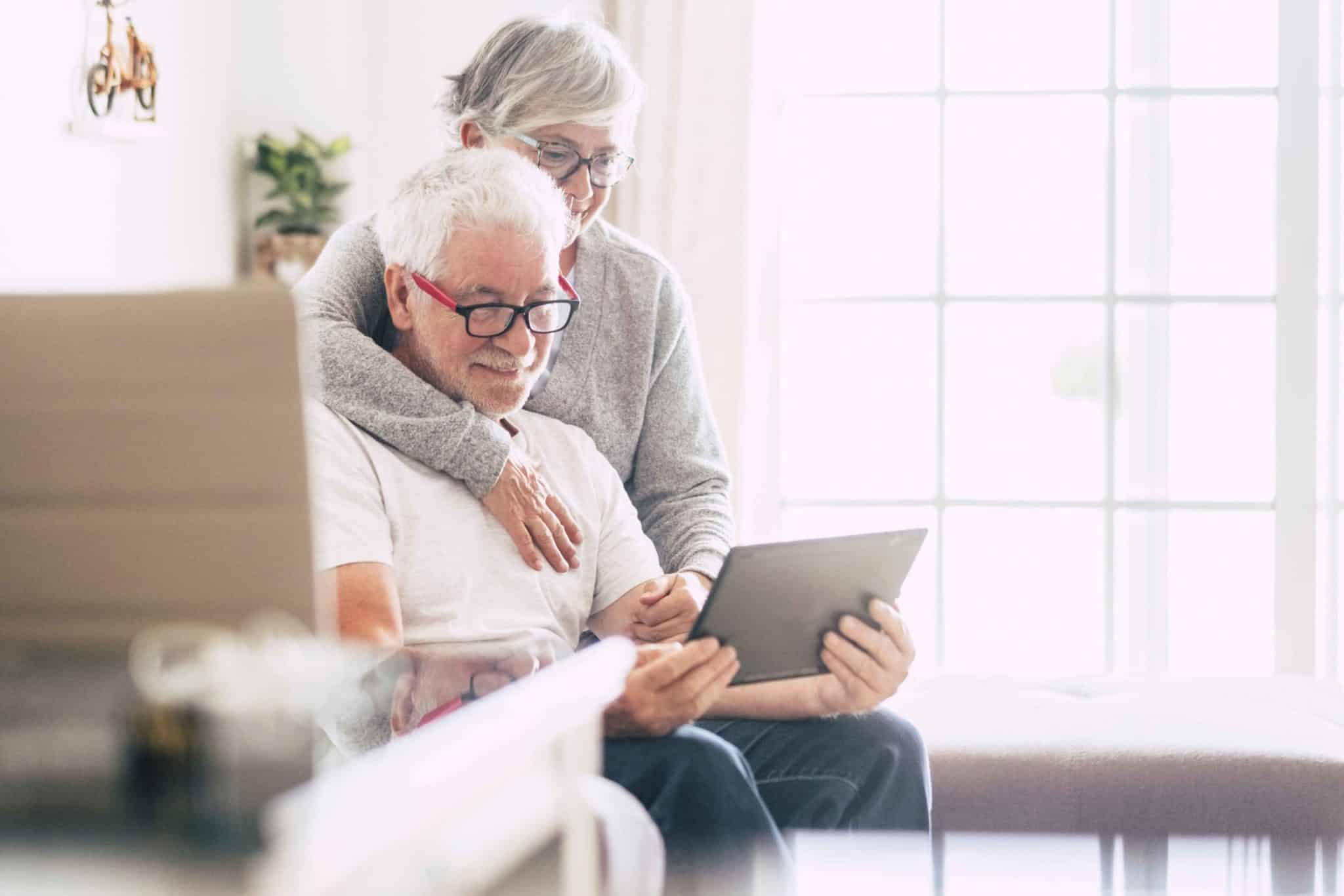 senior-couple-browse-chairs-on-tablet